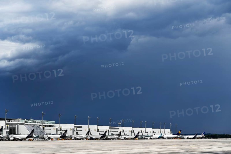 Overview Lufthansa Airlines, Star Alliance, Air Dolomiti, United Airlines aircraft at check-in position at Terminal 2 during approaching thunderstorm with rain and thunderclouds, Munich Airport, Upper Bavaria, Bavaria, Germany, Europe