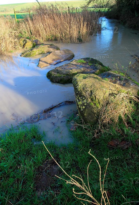 Stepping stones at Swallowhead Springs ancient sacred site, River Kennet, West Kennet, Wiltshire, England, UK