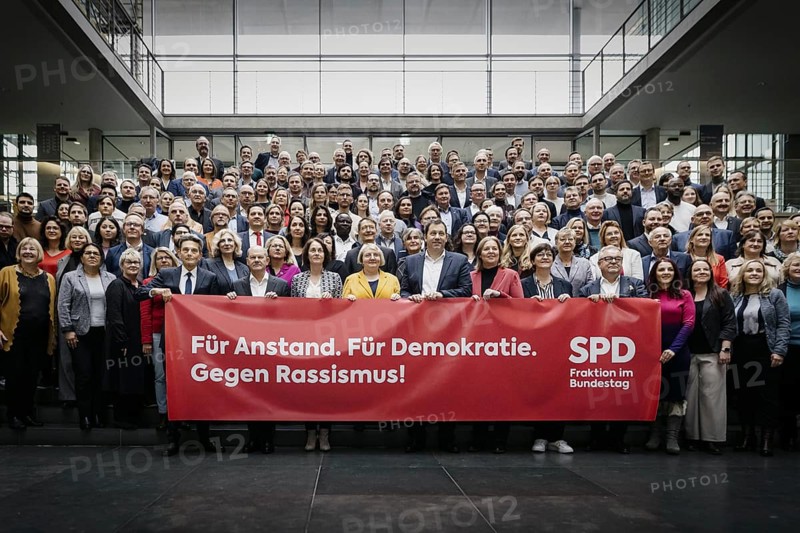 SPD Bundestag parliamentary group photographed as part of a group photo in the Paul Loebe Haus with a banner: For decency. For democracy. Against racism. In the front row from (L-R) Rolf Muetzenich, Chairman of the SPD parliamentary group, Ol
