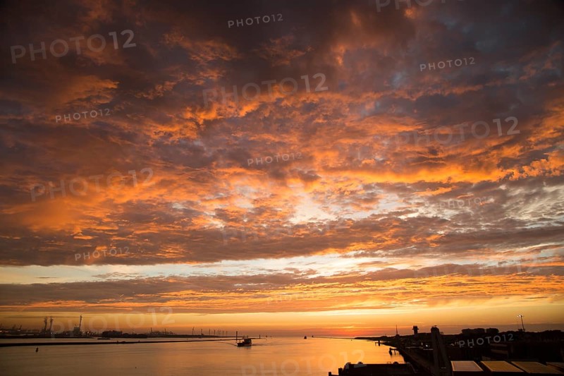 Sunset orange glow landscape clouds water, North Sea shipping, Port of Rotterdam, Hook of Holland, Netherlands