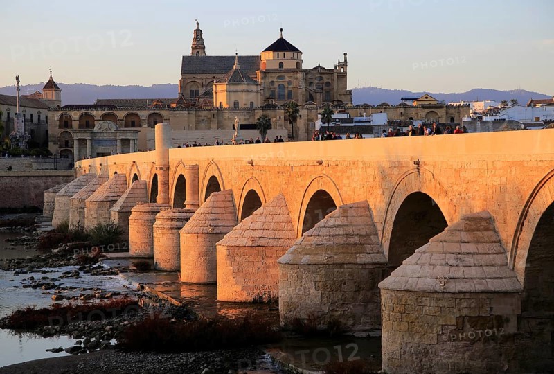 Roman bridge spanning river Rio Guadalquivir with Mezquita buildings, Cordoba, Spain, Europe