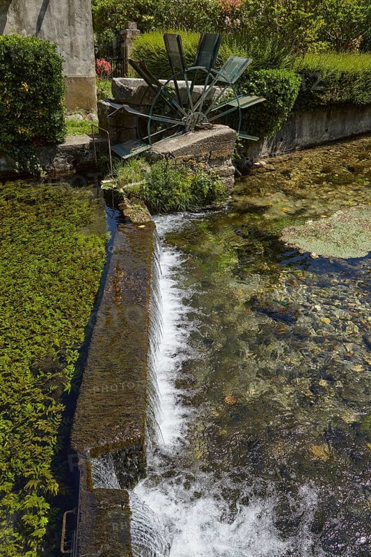 Weir with water mill wheel on a small canal in Goudargues, Departement Gard, Occitanie region, France, Europe