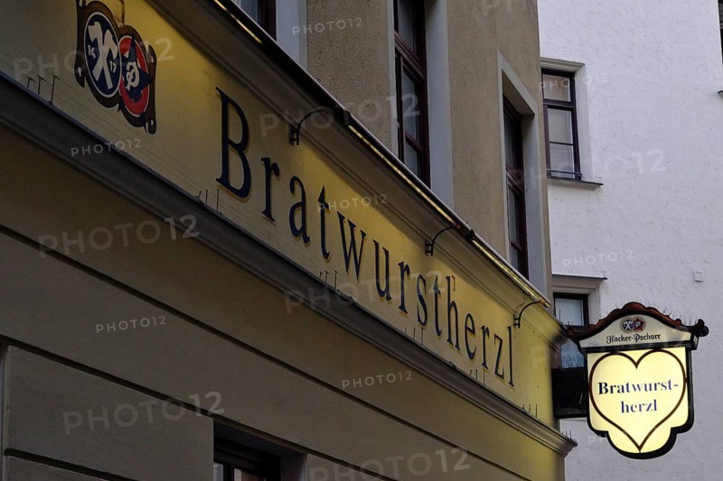 Illuminated sign of the traditional restaurant Bratwurstherzl at Viktualienmarkt, Munich, Bavaria, Germany, Europe