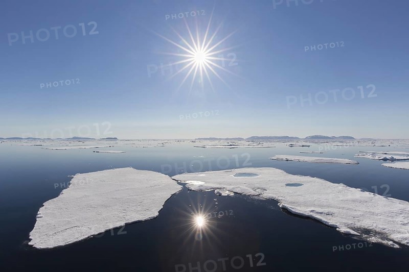 Midnight sun over the Arctic Ocean with drifting ice floes, north of the Arctic Circle at Nordaustlandet, Svalbard, Spitsbergen, Norway, Europe