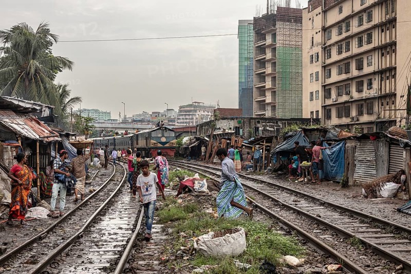 A train passes through an informal settlement built close to a railway line, Tejgaon Slum, Area, Dhaka, Bangladesh, Asia