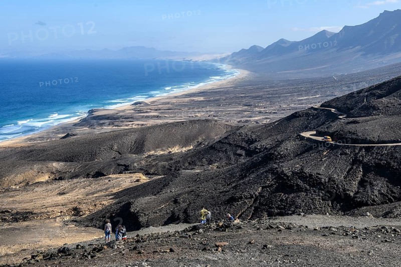 View from viewpoint Mirador di Cofete on surf in front of beach of East Atlantic Atlantic landscape of extinct primeval volcanoes volcanic landscape of old lava on west coast of peninsula Jandia of Fuerteventura island, Cofete, Fuerteventura, Canary Islands, Spain, Europe