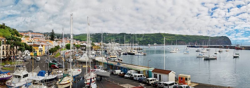 Panoramic view of a busy marina of Horta with boats and surrounded by hilly landscape, Horta, Faial Island, Azores, Portugal, Europe