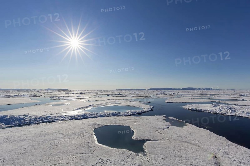 Midnight sun over the Arctic Ocean with drifting ice floes, north of the Arctic Circle at Nordaustlandet, Svalbard, Spitsbergen, Norway, Europe