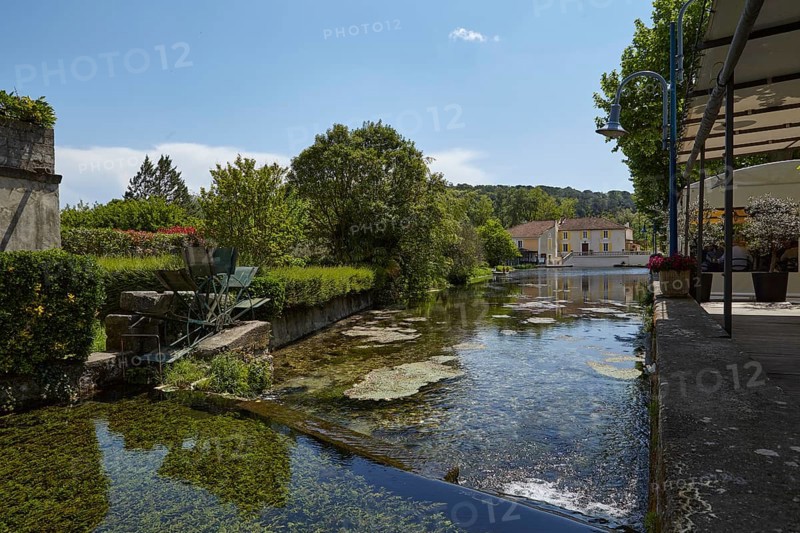 Small canal with weir and mill wheel in Goudargues, Departement Gard, Occitanie region, France, Europe