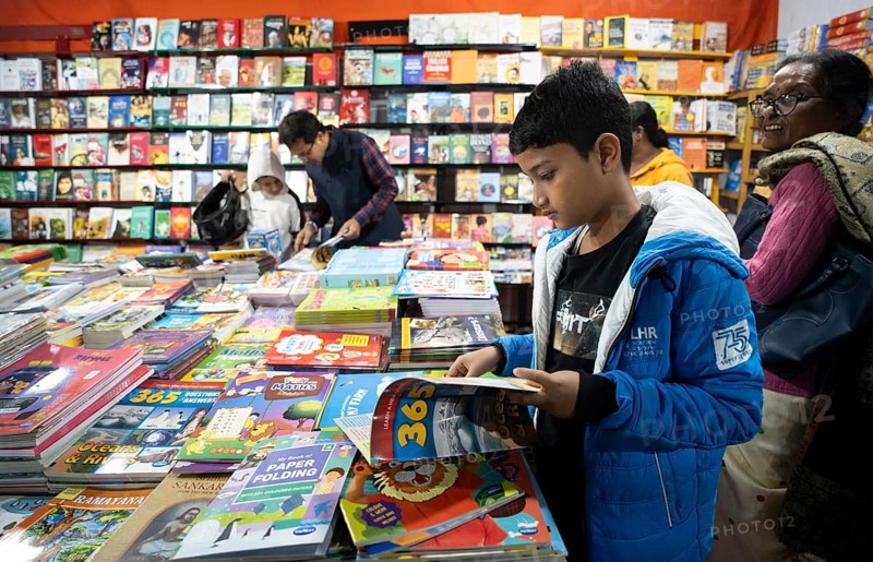 Book readers browsing books at a stall during Assam Book Fair, in Guwahati, Assam, India on 29 December 2023