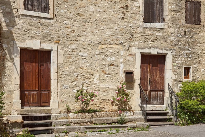Facades of old houses with doors, windows and shutters in Goudargues, Departement Gard, Occitanie region, France, Europe