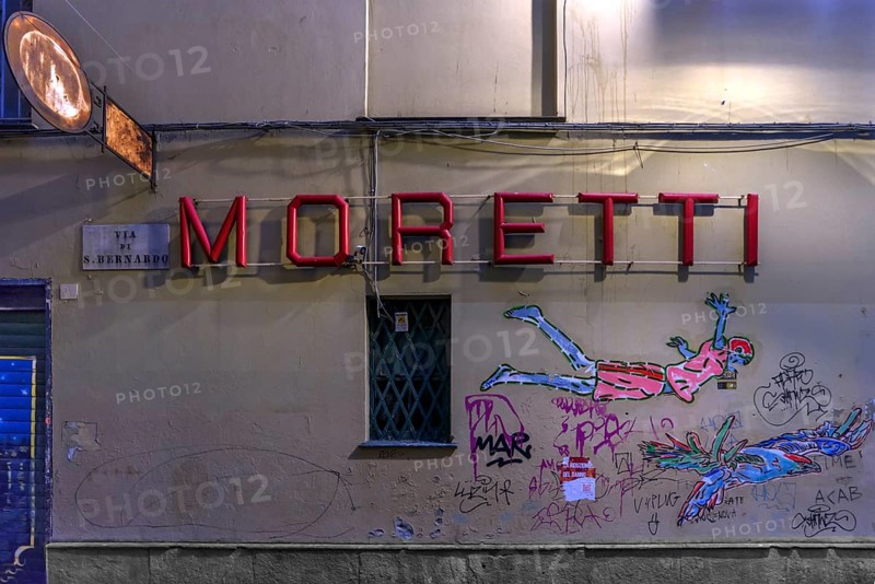 Moretti, lettering of a bar, underneath graffiti on a house wall, historic centre, Genoa, Italy, Europe