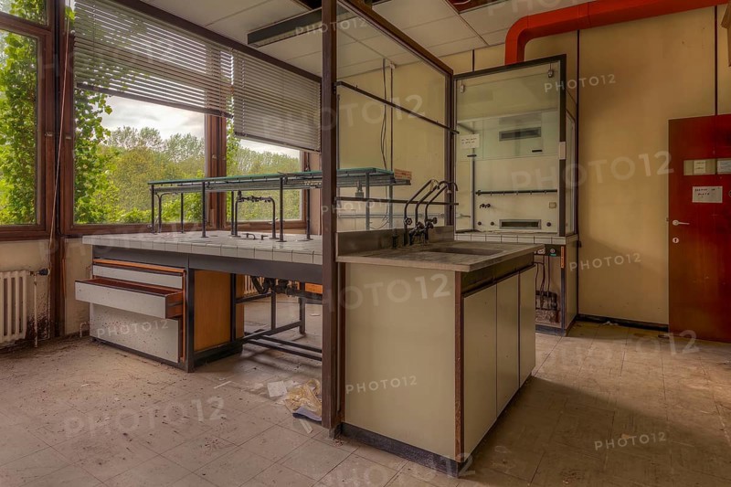 An empty laboratory room with a view of nature through windows, littered with scraps of paper, biotech, abandoned university, lost place, Sint-Genesius-Rode, Belgium, Europe