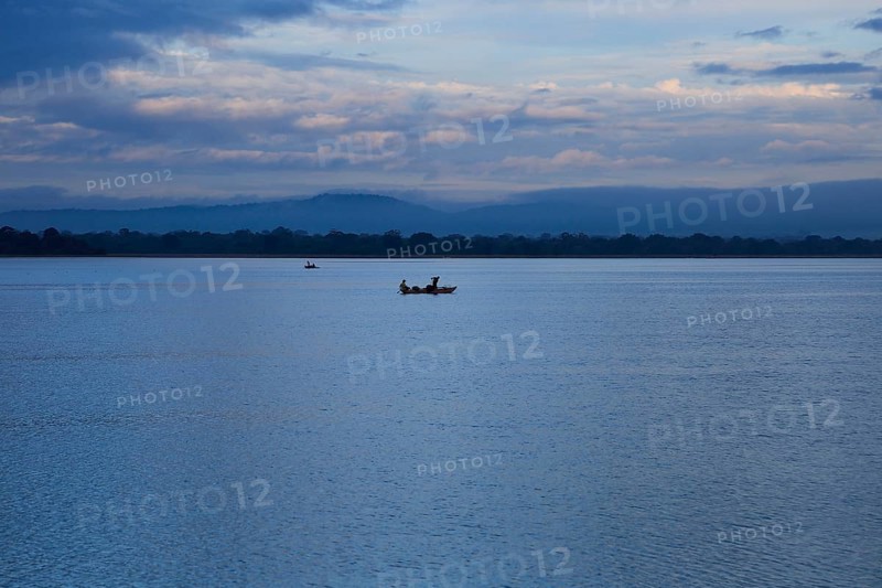 Fishing canoes in calm lake water Polonnaruwa, North Central Province, Sri Lanka, Asia