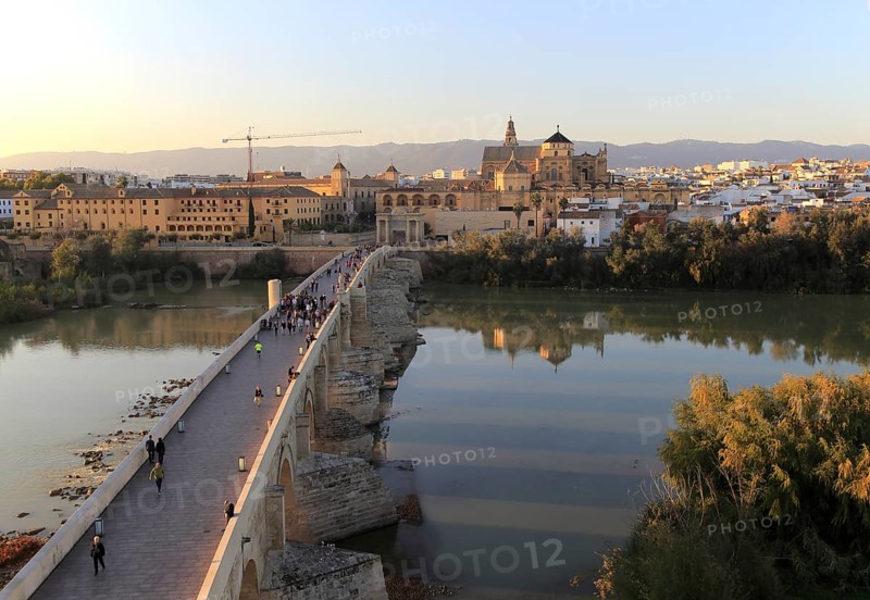 Roman bridge spanning river Rio Guadalquivir with Mezquita cathedral buildings, Cordoba, Spain, Europe