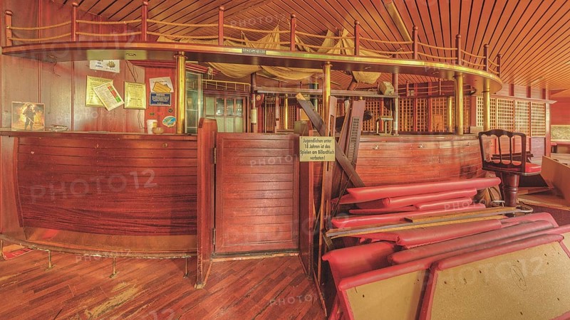 An empty bar with a wooden counter and bar stools that conveys a nostalgic atmosphere, Bad am Park, Lost Place, Essen, North Rhine-Westphalia, Germany, Europe