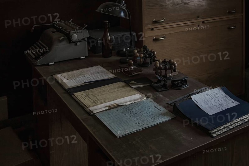 An old office with antique typewriter and desk lamp in the semi-darkness, Dahlhausen railway depot, Lost Place, Dahlhausen, Bochum, North Rhine-Westphalia, Germany, Europe