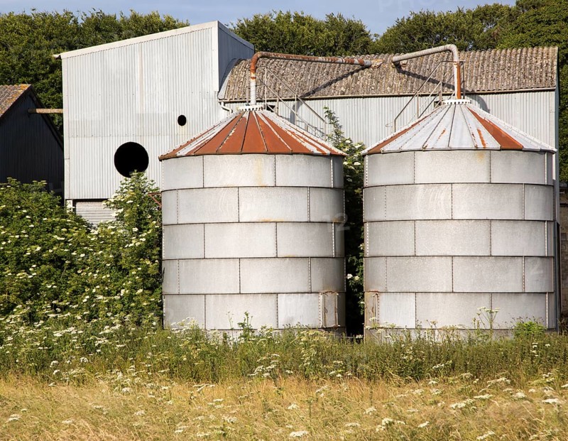 Old steel storage tanks and barns, West Kennet, Wiltshire, England, UK