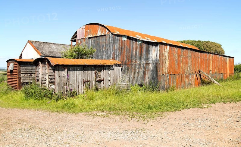 Rusty red barn the Gower peninsula, near Swansea, South Wales, UK