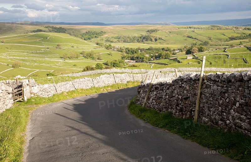 Country lane and dry stonewalls, Malham, Yorkshire Dales national park, England, UK