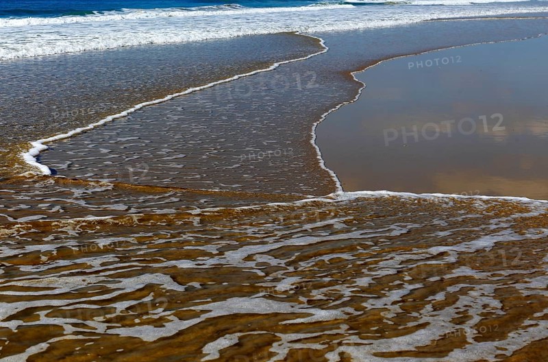Wave breaking on sandy beach at Conil de la Frontera, Cadiz Province, Spain, Europe