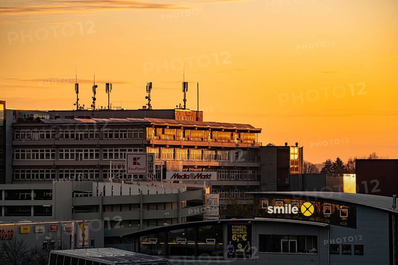 Building with antennas on the roof against a sky flooded with warm light at sunset, Wilferdinger Hoehe, Pforzheim, Germany, Europe