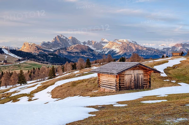 Alpine hut with snow, spring on the Seiser Alm, Seceda, Dolomites, South Tyrol