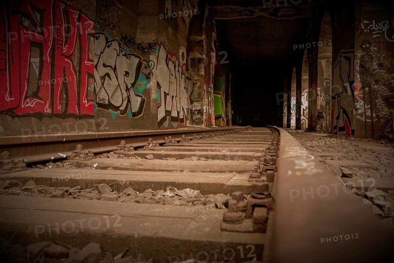 Railway tracks lead into the depths, accompanied by wall graffiti, former railway branch Rethel, Lost Place, Flingern, Duesseldorf, North Rhine-Westphalia, Germany, Europe
