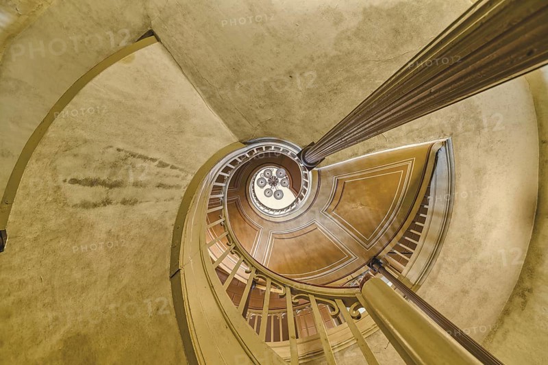A detailed view of a spiral staircase with a spiral banister in beige tones, Schachtrupp Villa, Lost Place, Osterode am Harz, Lower Saxony, Germany, Europe