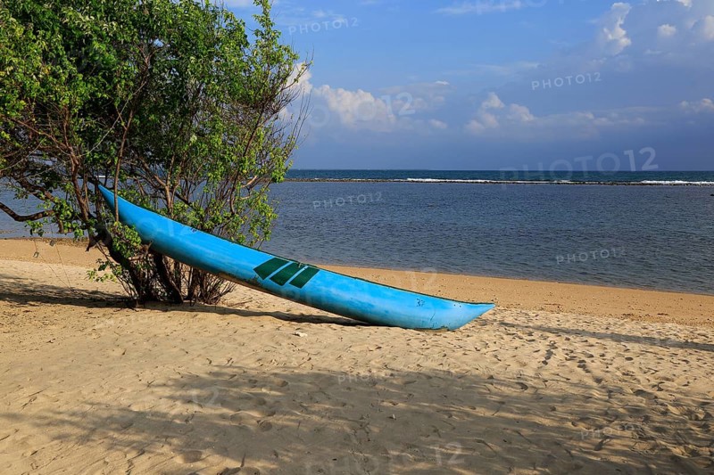 Canoe on sandy tropical beach at Pasikudah Bay, Eastern Province, Sri Lanka, Asia
