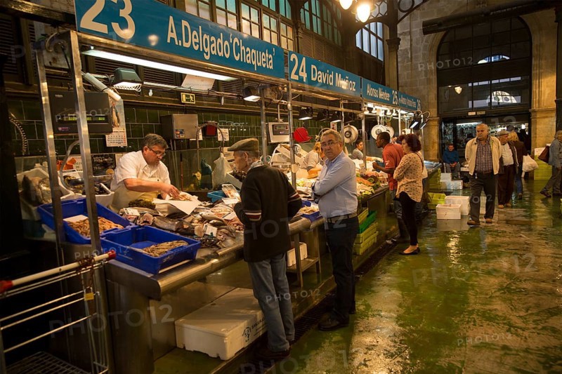 People shopping at fishmonger stalls inside historic covered market building, Jerez de la Frontera, Spain, Europe