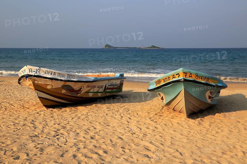 Boats on tropical beach at Nilavelli, Trincomalee, Sri Lanka, Asia with Pigeon Island in background, Asia