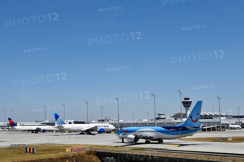 TUI Boeing B737-800 MAX taxiing on apron in front of Terminal 1 with tower, Munich Airport, Upper Bavaria, Bavaria, Germany, Europe