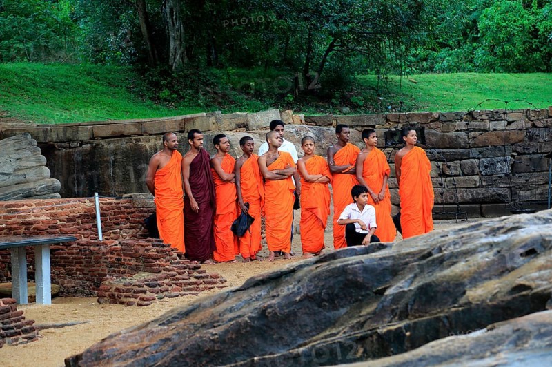 Orange robed monks, Gal Viharaya, UNESCO World Heritage Site, the ancient city of Polonnaruwa, Sri Lanka, Asia