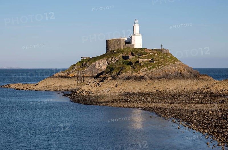 Lighthouse at low tide Mumbles Head, Gower peninsula, near Swansea, South Wales, UK