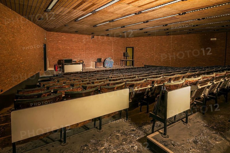 An abandoned lecture theatre with damaged wooden seats and a spherical model on the stage, Biotech, abandoned university, Lost Place, Sint-Genesius-Rode, Belgium, Europe