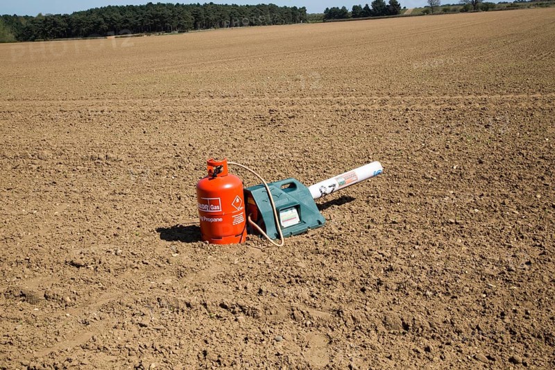 Scatterer gas canister bird scarer on farmland, Sutton, Suffolk, England, UK