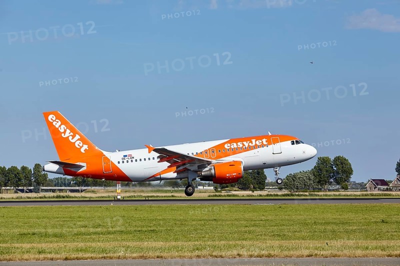 EasyJet Airbus A319-111 with registration OE-LQM lands on the Polderbaan, Amsterdam Schiphol Airport in Vijfhuizen, municipality of Haarlemmermeer, Noord-Holland, Netherlands