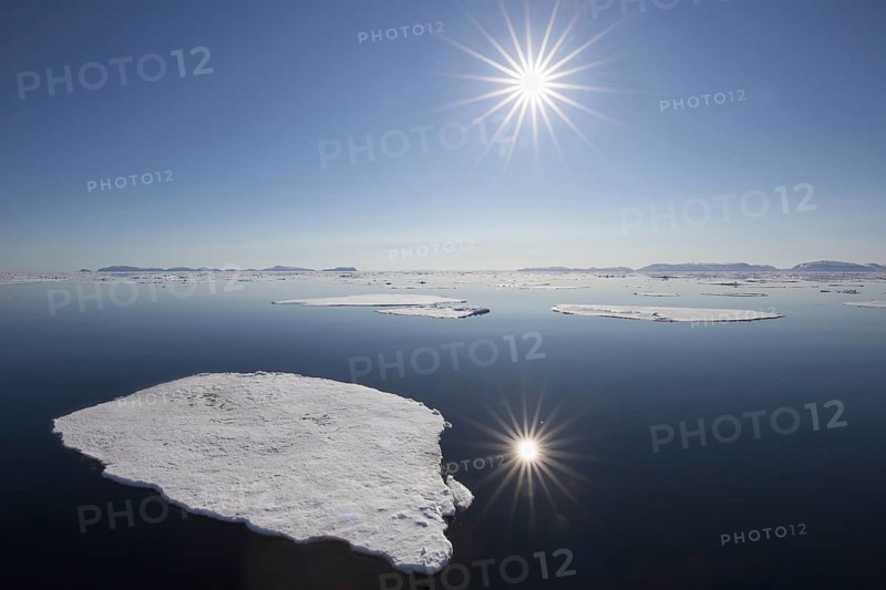 Midnight sun over the Arctic Ocean with drifting ice floes, north of the Arctic Circle at Nordaustlandet, Svalbard, Spitsbergen, Norway, Europe