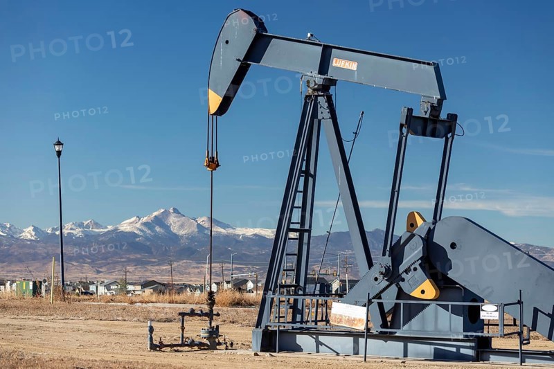 Frederick, Colorado, An oil well near a housing subdivision on Colorado's front range, with Mount Meeker and Longs Peak in Rocky Mountain National Park in the distance