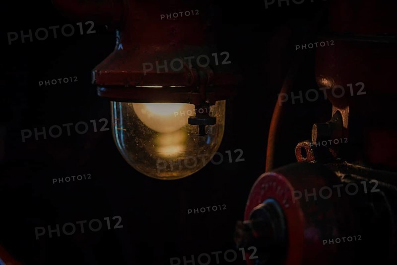 An atmospheric light from an antique lamp in a dark part of a locomotive, Dahlhausen railway depot, Lost Place, Dahlhausen, Bochum, North Rhine-Westphalia, Germany, Europe