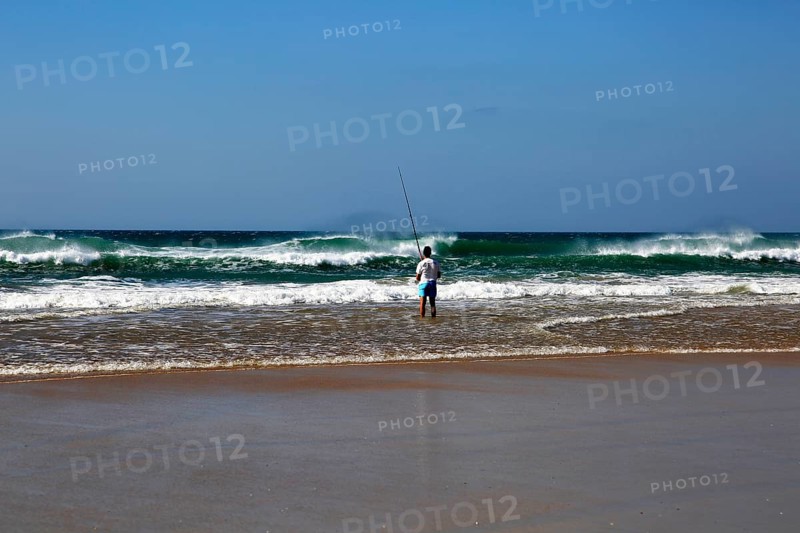 Man fishing from the beach at Conil de la Frontera, Cadiz province, Spain, Europe