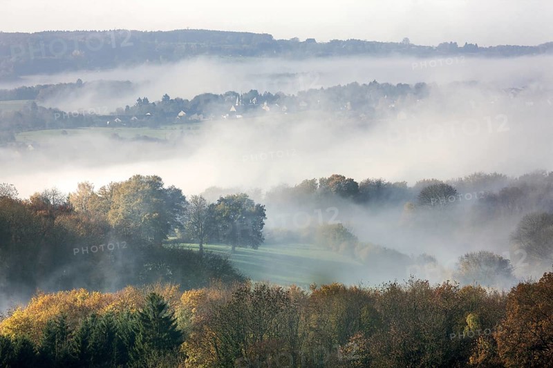 View over fileds and the village Sougne-Remouchamps in the mist, Aywaille, Liege, Belgian Ardennes, Belgium, Europe