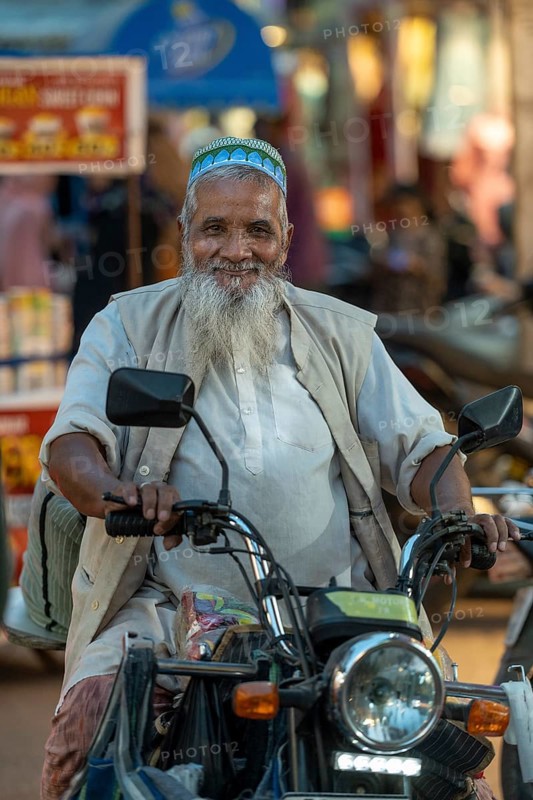 Muslim man on motorbike, bazaar, at Charminar, Hyderabad, Andhra Pradesh, India, Asia