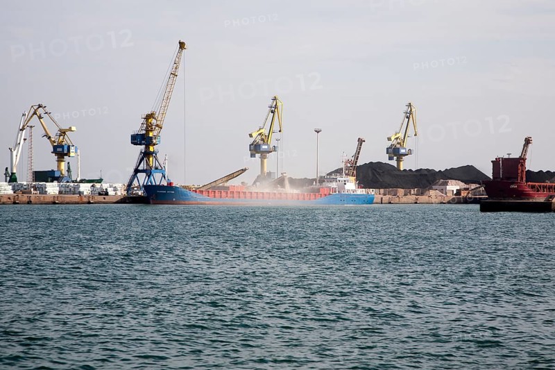 Cranes loading bulk carrier ship with rock ore at the port of Beni Ansar, Morocco, north Africa, Africa