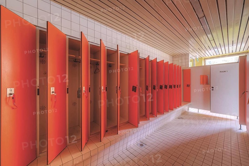 A set of red changing cubicles in a clean, empty room, Bad am Park, Lost Place, Essen, North Rhine-Westphalia, Germany, Europe