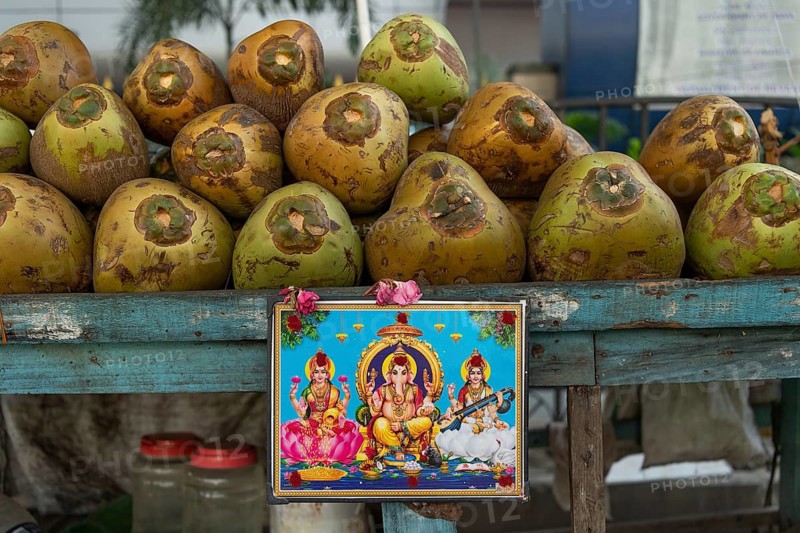 Hindu idol, coconut sale on the street, Chennai, Tamil Nadu, India, Asia