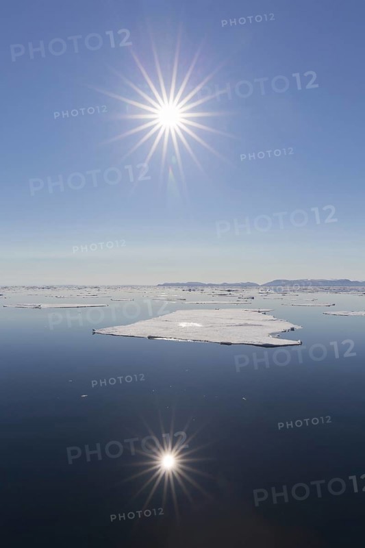 Midnight sun over the Arctic Ocean with drifting ice floes, north of the Arctic Circle at Nordaustlandet, Svalbard, Spitsbergen, Norway, Europe
