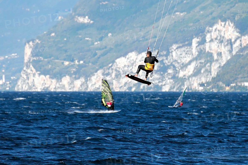 Windsurfers surfing in strong winds on Lake Garda near Malcesine, Veneto, Italy, Europe