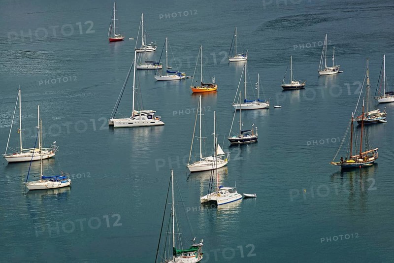 Several sailing boats on calm water with visible reflections, Monte da Guia, Horta, Faial Island, Azores, Portugal, Europe
